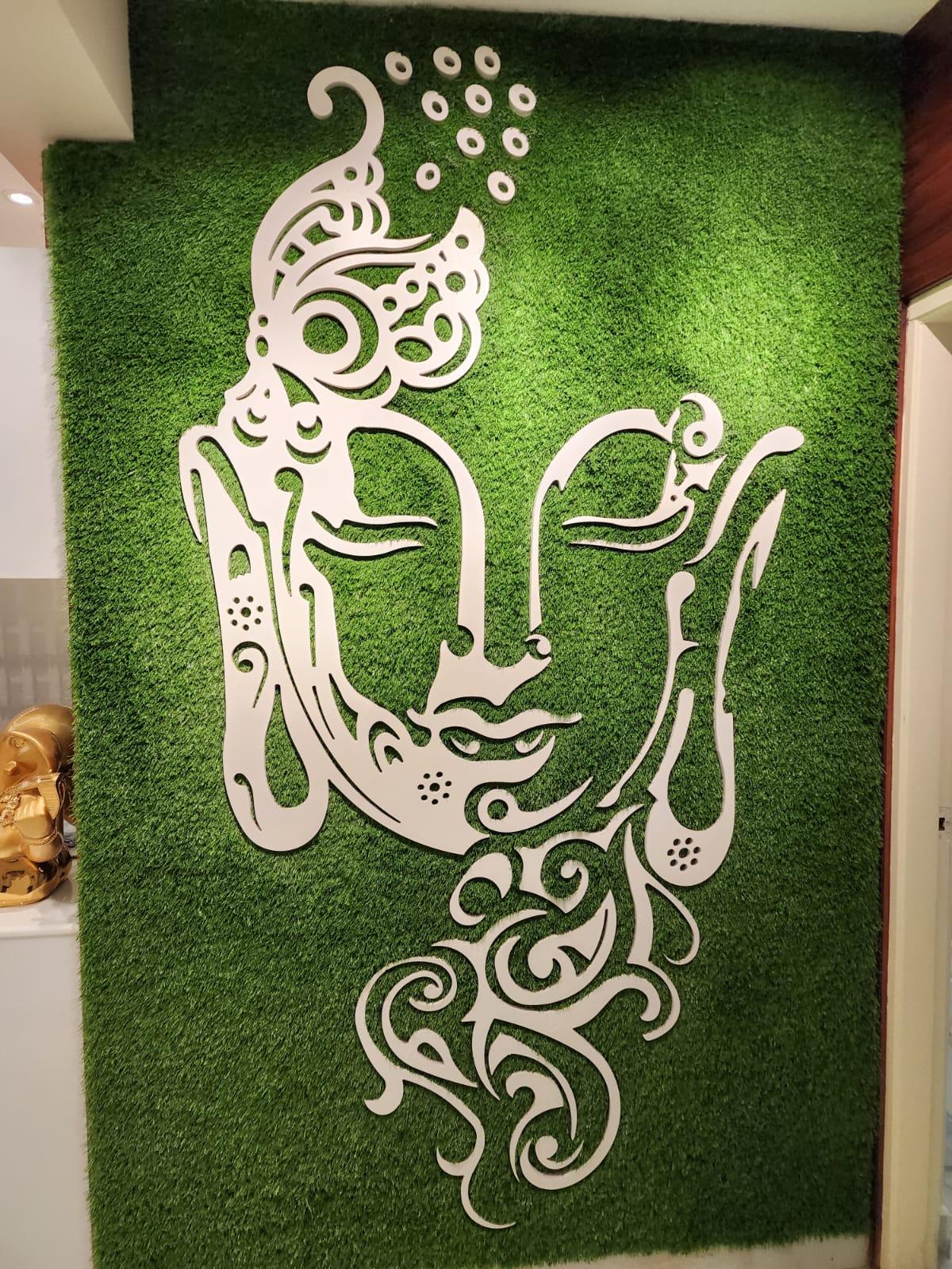 Buddha CNC art on artificial grass wall in Vizag