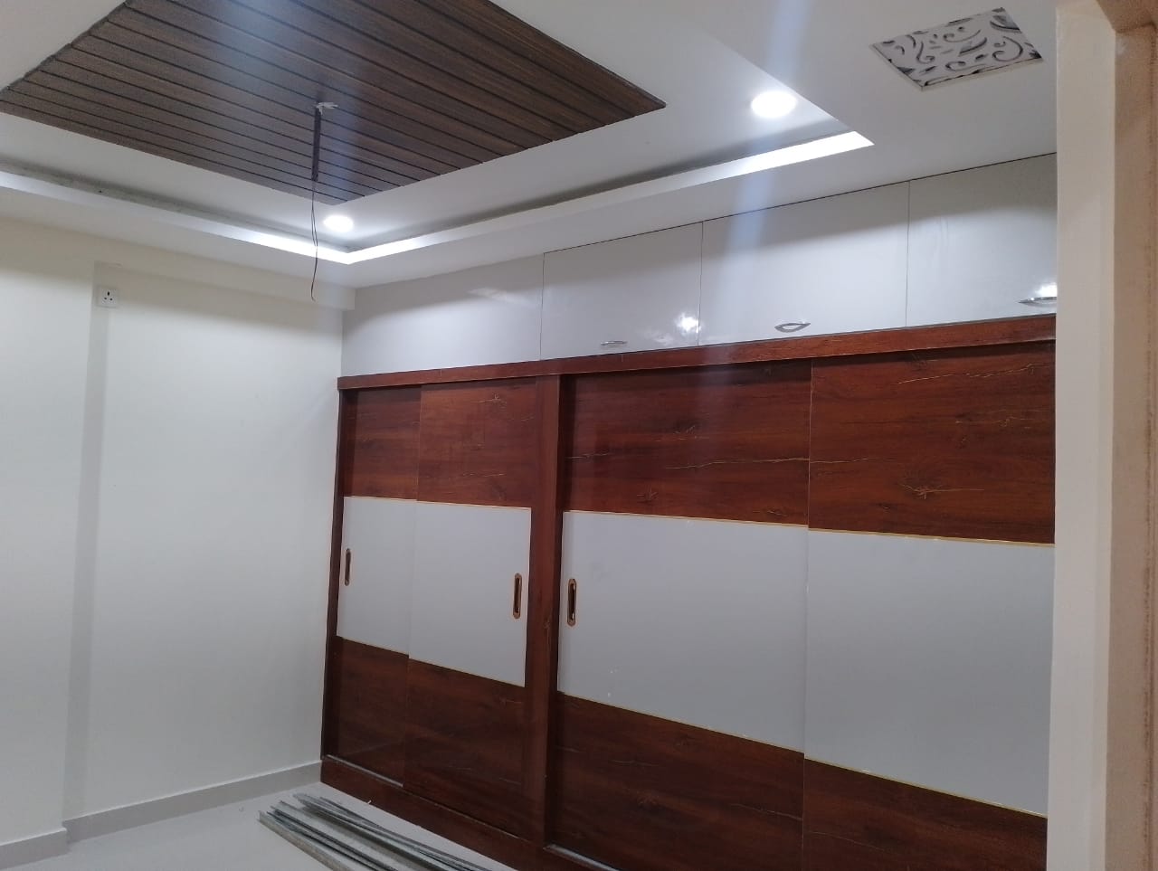 Sliding wardrobe with wooden ceiling rafter in Vizag